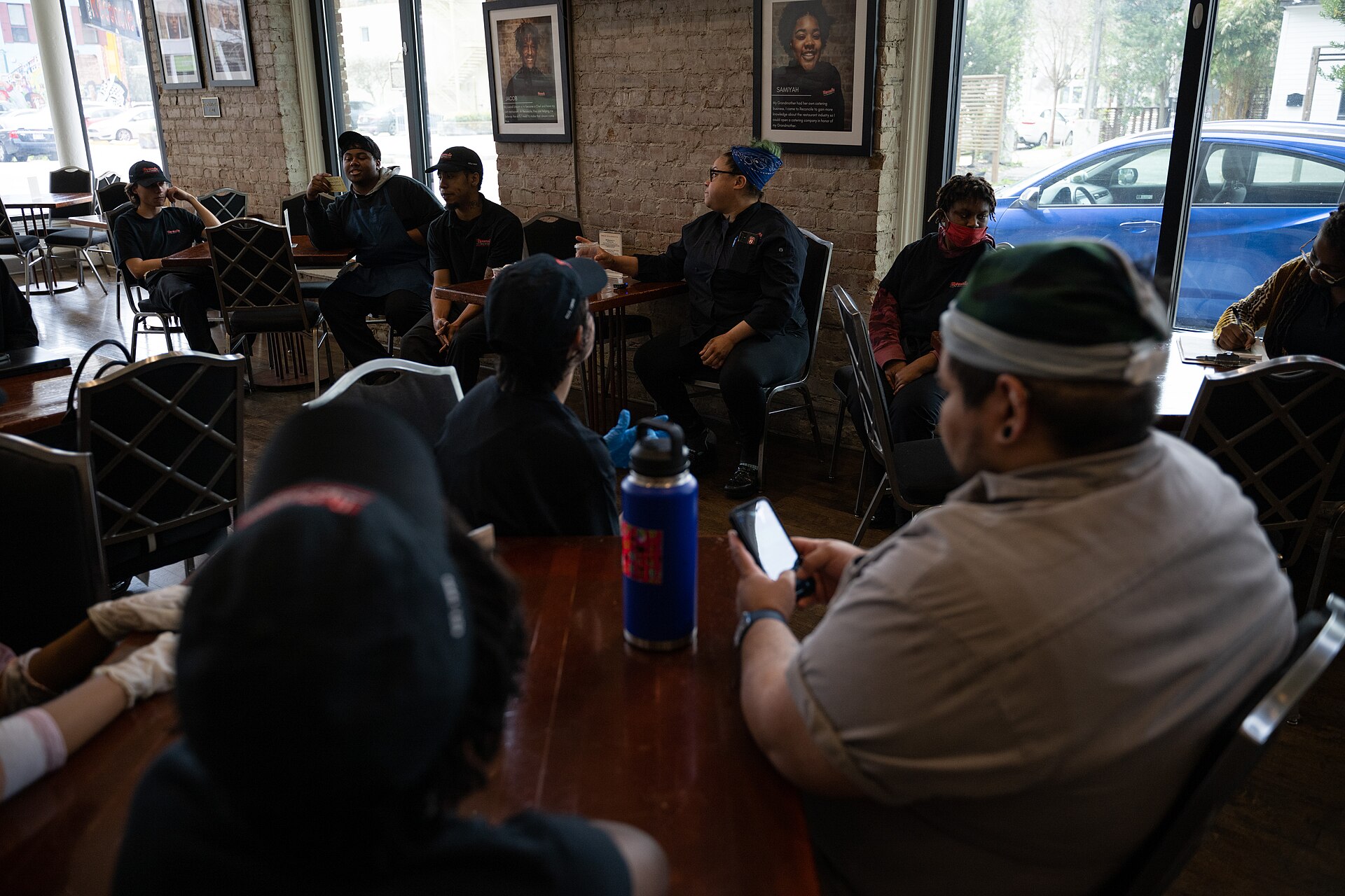 Trainer advocates and interns at Café Reconcile have a meeting before the start of the service in New Orleans, La., Feb. 16, 2023. Café Reconcile runs a volunteer program serving self-initiated youth ages 16-24 who reside in the Greater New Orleans area. Café Reconcile combines hands-on food service training with classroom instruction, individual case management, job placement services, and follow-up support to develop a participant’s ability to become independent, self-sufficient, and successfu