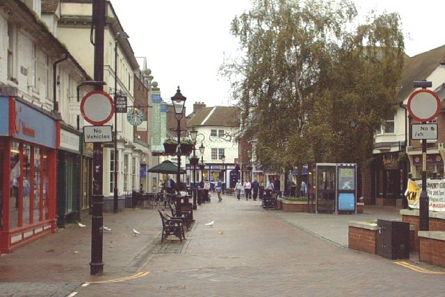 Ashford Town Centre - Upper High Street. Shown on a rather dull Sunday morning, this street used to be the main A20 from London to Folkestone / Dover. Now lined with all the usual stores, there is a bandstand to the right of the photograph.